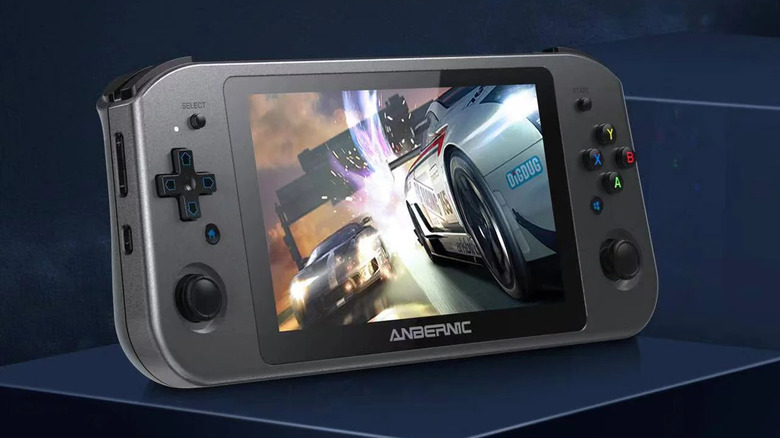 A black Anbernic Win600 showing a racing game.