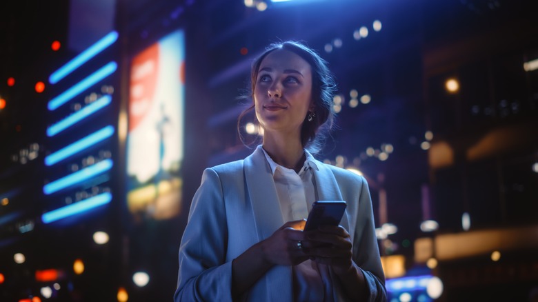 Person using phone in city