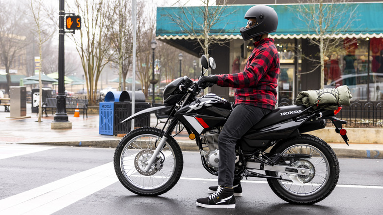 person riding Honda XR150L street