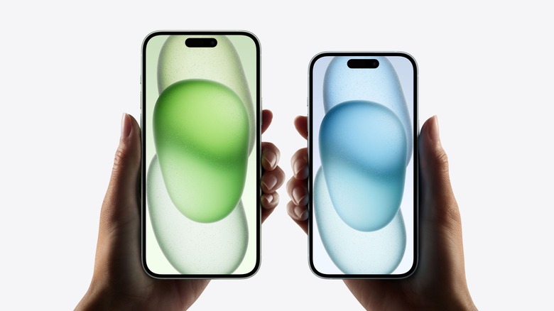 hands holding iPhone 15 phones