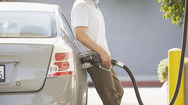 man filling up car