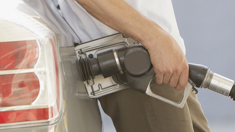 man filling up car