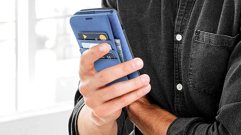 hand holding blue wallet case