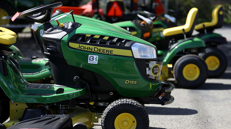A lineup of John Deere riding mowers
