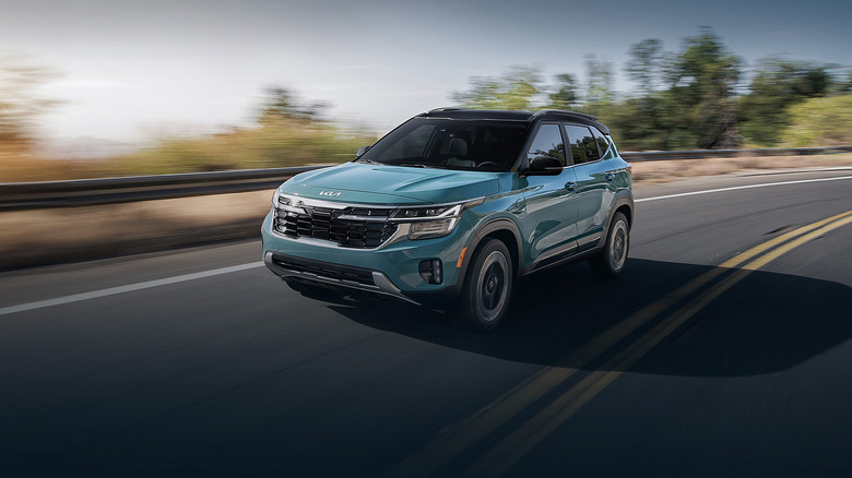 A teal Kia Seltos on a highway