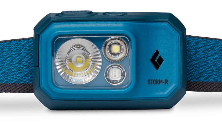 A blue headlamp with a blue strap from Black Diamond