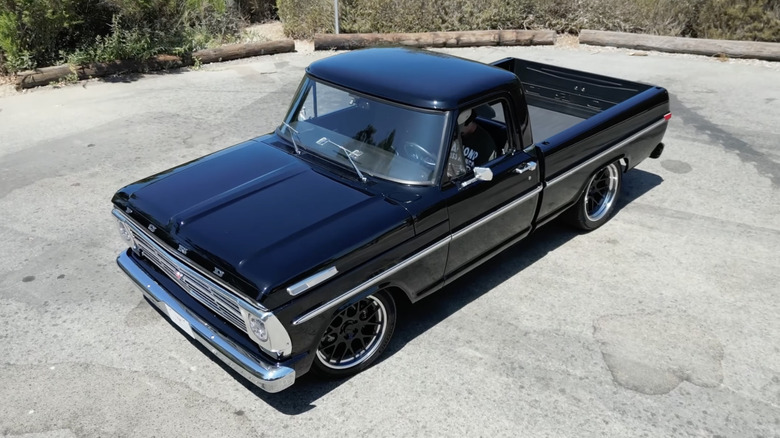 A black and chrome Velocity Restorations Ford F-100 restomod truck pictured from above.