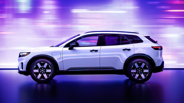 A white Honda Prologue on a stage with an LED screen background