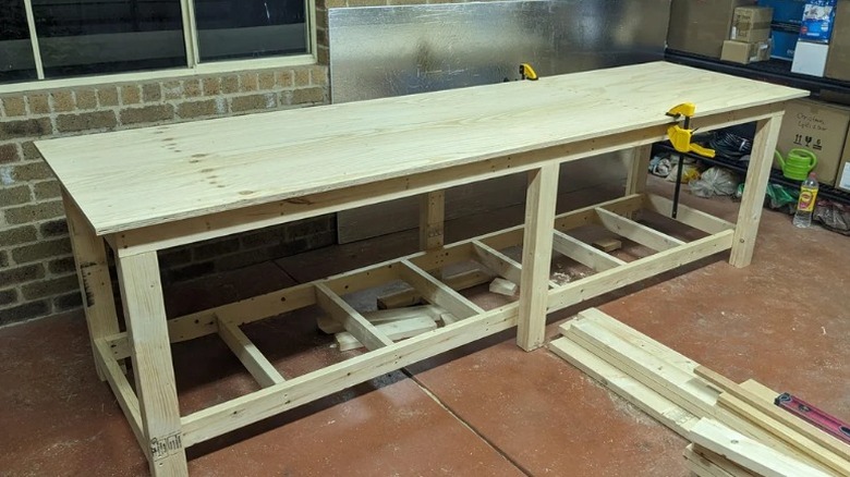 Work bench with plywood top clamped on in garage