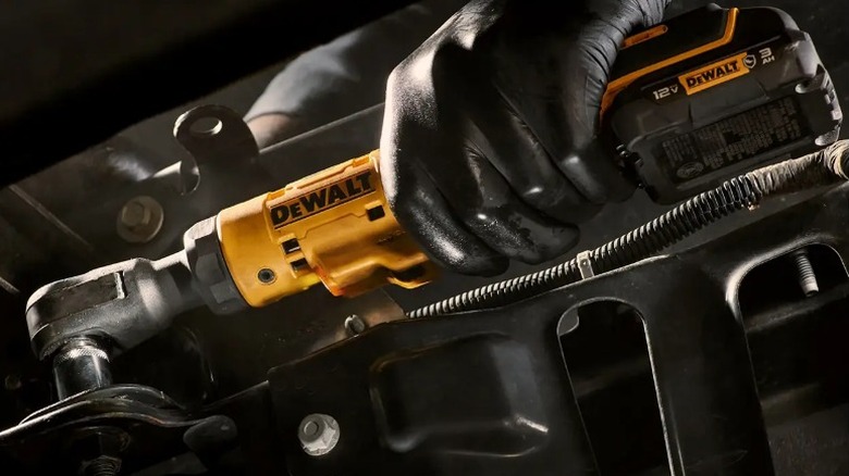 Person using DeWalt Xtreme 12V Max Variable Speed ⅜-inch Ratchet on car