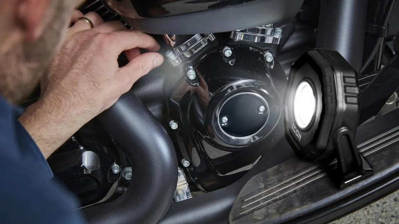 Icon 2,100-lumen LED Rechargeable Magnetic Compact Floodlight used on a car engine as its fixed