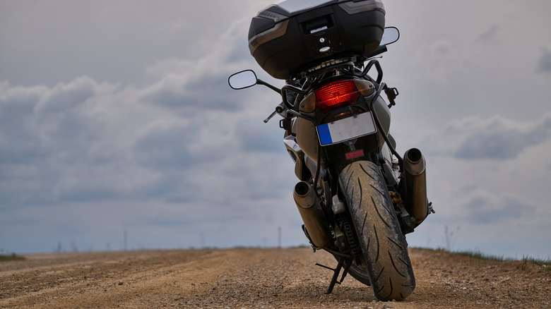 touring motorcycle parked dirt road