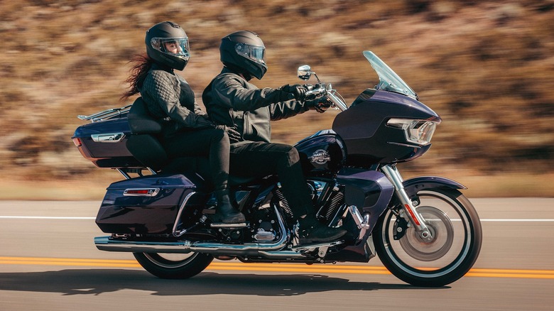 A couple enjoying a two-up ride on a Harley-Davidson Road Glide Limited
