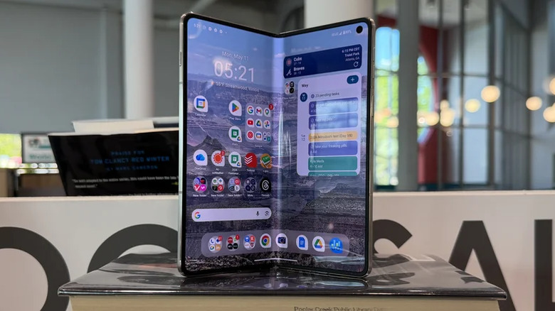 A Motorola Razr Fold on a pile of books