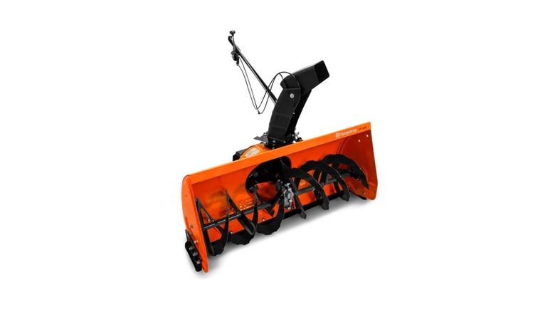 An orange Husqvarna snowblower attachment for a riding mower.
