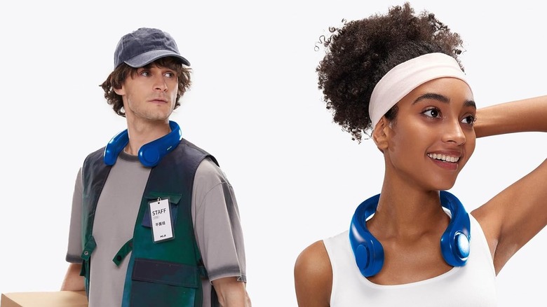 man and woman wearing neckfan