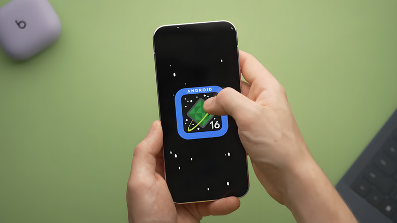 Person holding phone Android 16