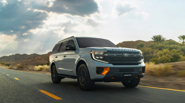 2026 Ford Expedition driving on desert road, front-right view