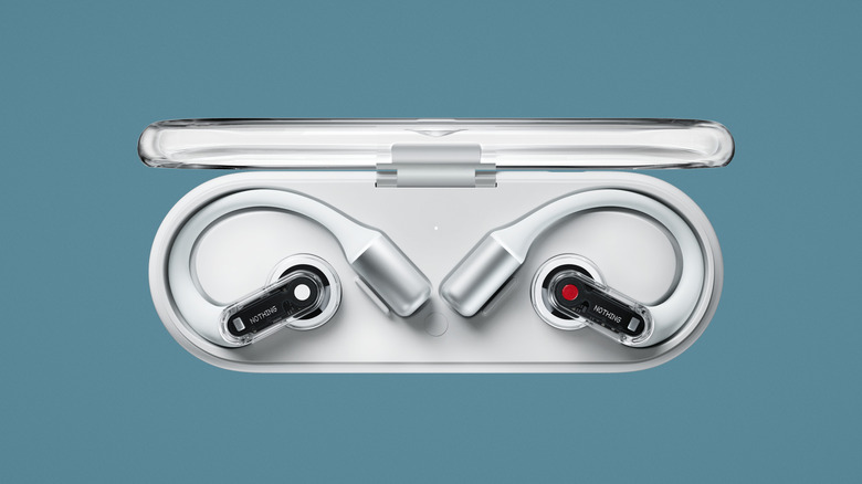 White Nothing Ear Open earbuds in their case case on a blue background