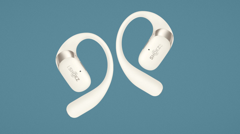 White Shocks OpenFit 2 earbuds on a blue background