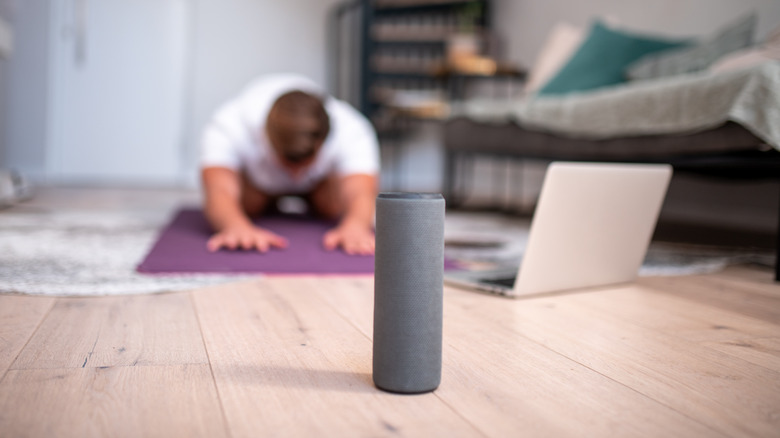 Man doing yoga with Bluetooth speaker