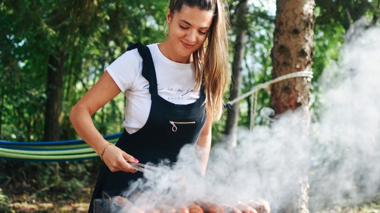 woman grilling food while camping