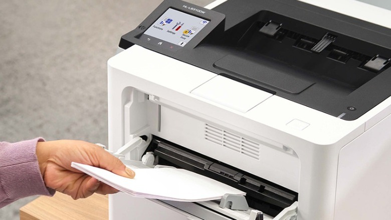 Hand feeding paper into a Brother HL-L6310DW printer