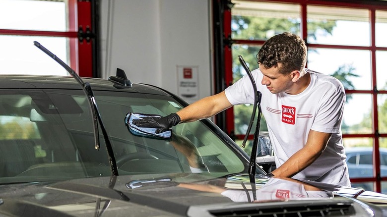 Man applying Griot's Garage Glass Sealant to a windshield
