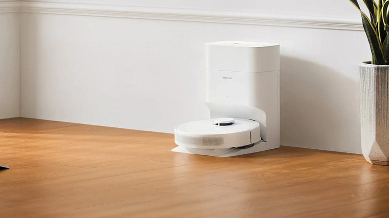 Dreame D10 Plus Gen 2 on the floor and being charged at its station.
