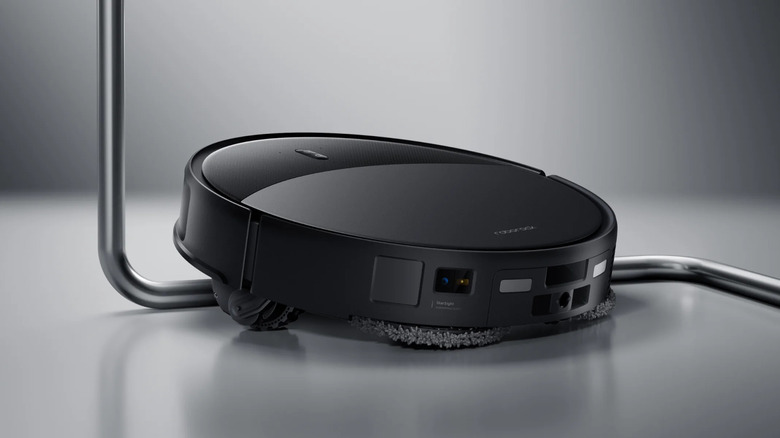 The Roborock Saros using its wheels to climb over the base of a chair.