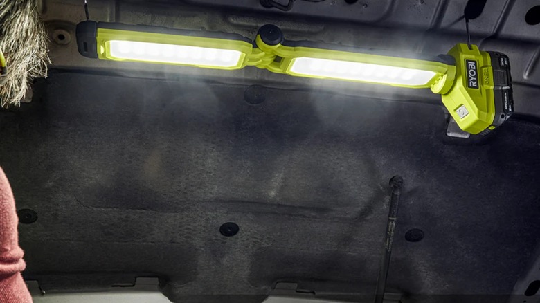 Ryobi 18V One+ LED Workbench Light attached to an open car hood