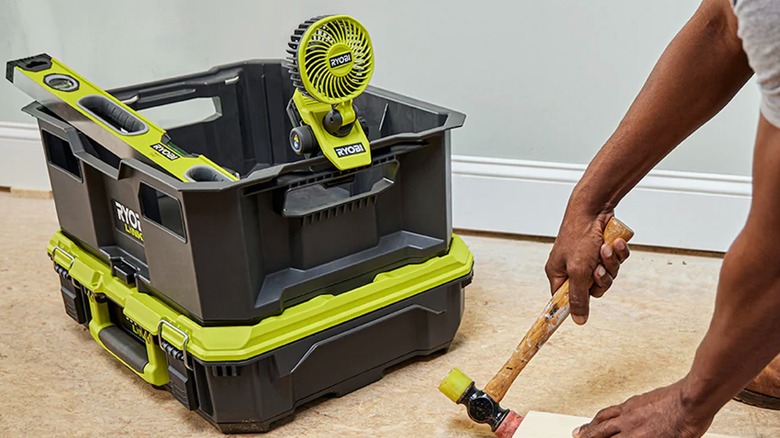Ryobi USB Lithium Clamp Fan and other Ryobi gear as a person works