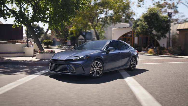 A side shot of a gray 2026 Toyota Camry driving