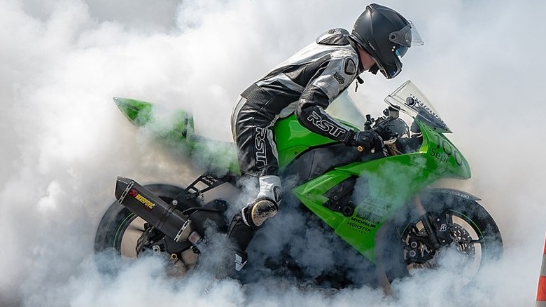 Rider doing a burnout in a Kawasaki Ninja ZX-10R