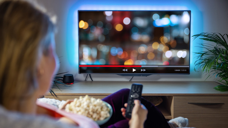 woman watching a livestream on TV