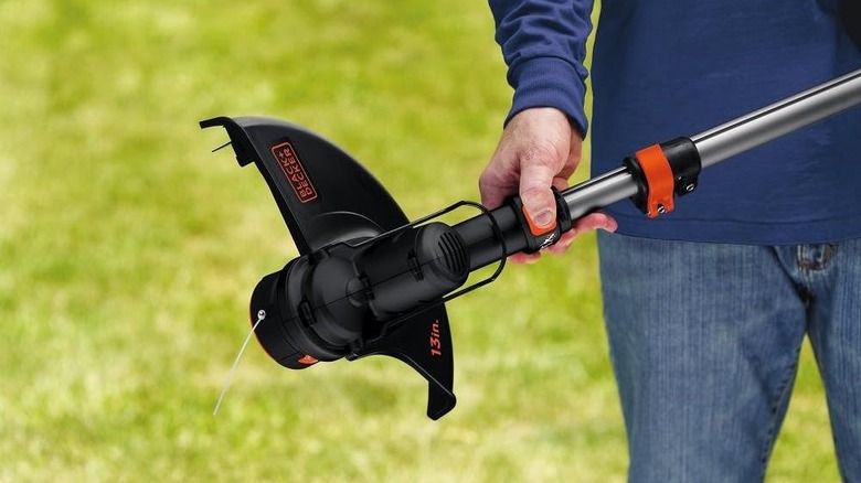 A man holding the Black+Decker LST136.