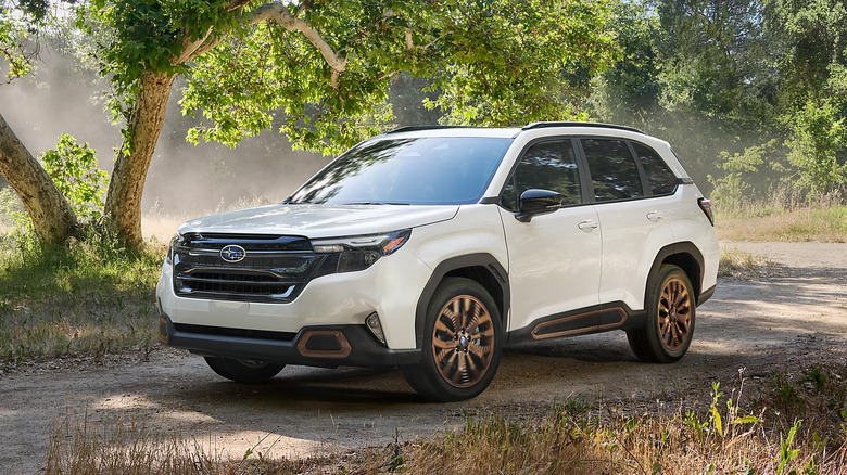 A white 2025 Subaru Forester Sport driving