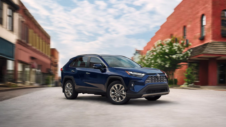 A blue 2025 Toyota RAV4 driving in the streets