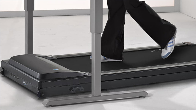 A person walking on the LifeSpan TR1200-GlowUp.