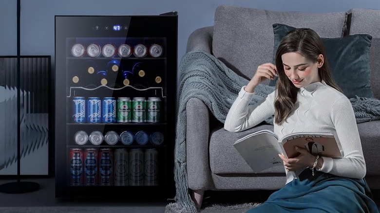 woman reading next to beverage cooler