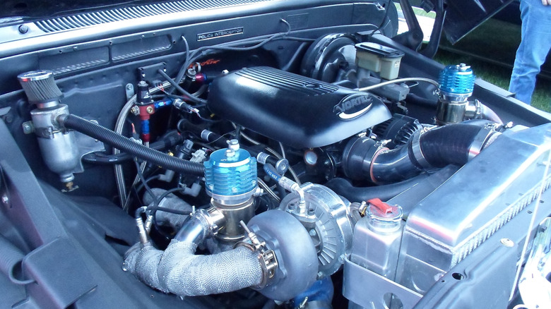 A twin-turbo Vortec V8 engine installed in a classic vehicle with the hood open.