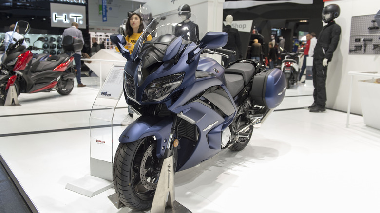 A dark blue Yamaha FJR1300 AE on display at a trade fair