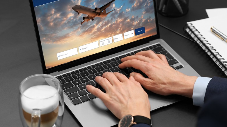 man using laptop travel site