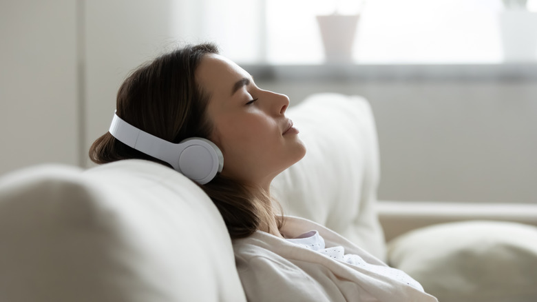 women with headphones sleeping