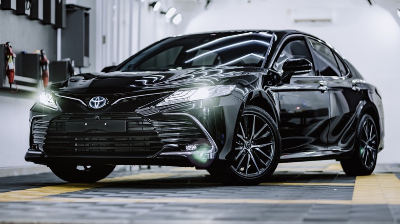 Black Camry in garage