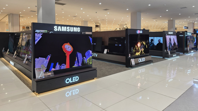 Row of OLED television displays in a retail store