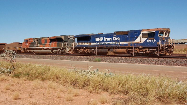A BHP Iron Ore freight train on the tracks.