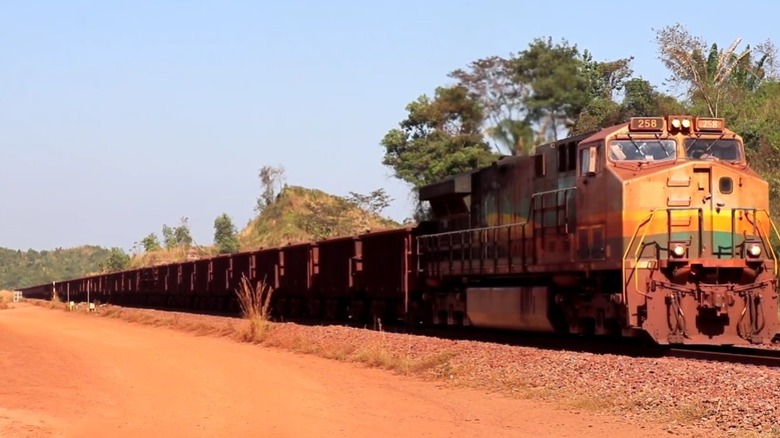 A Brazilian freight train passing along the track.