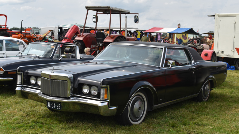 A black 1970 lincoln Continental Mark III with the Ford 460 Big block engine at an auto show