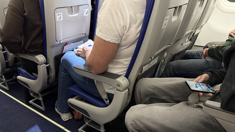 Small, tight seats on an airplane with very little legroom
